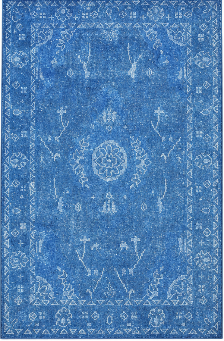 A rectangular blue area rug with a distressed, vintage-style traditional pattern in lighter blue and white, shown flat against a white background.